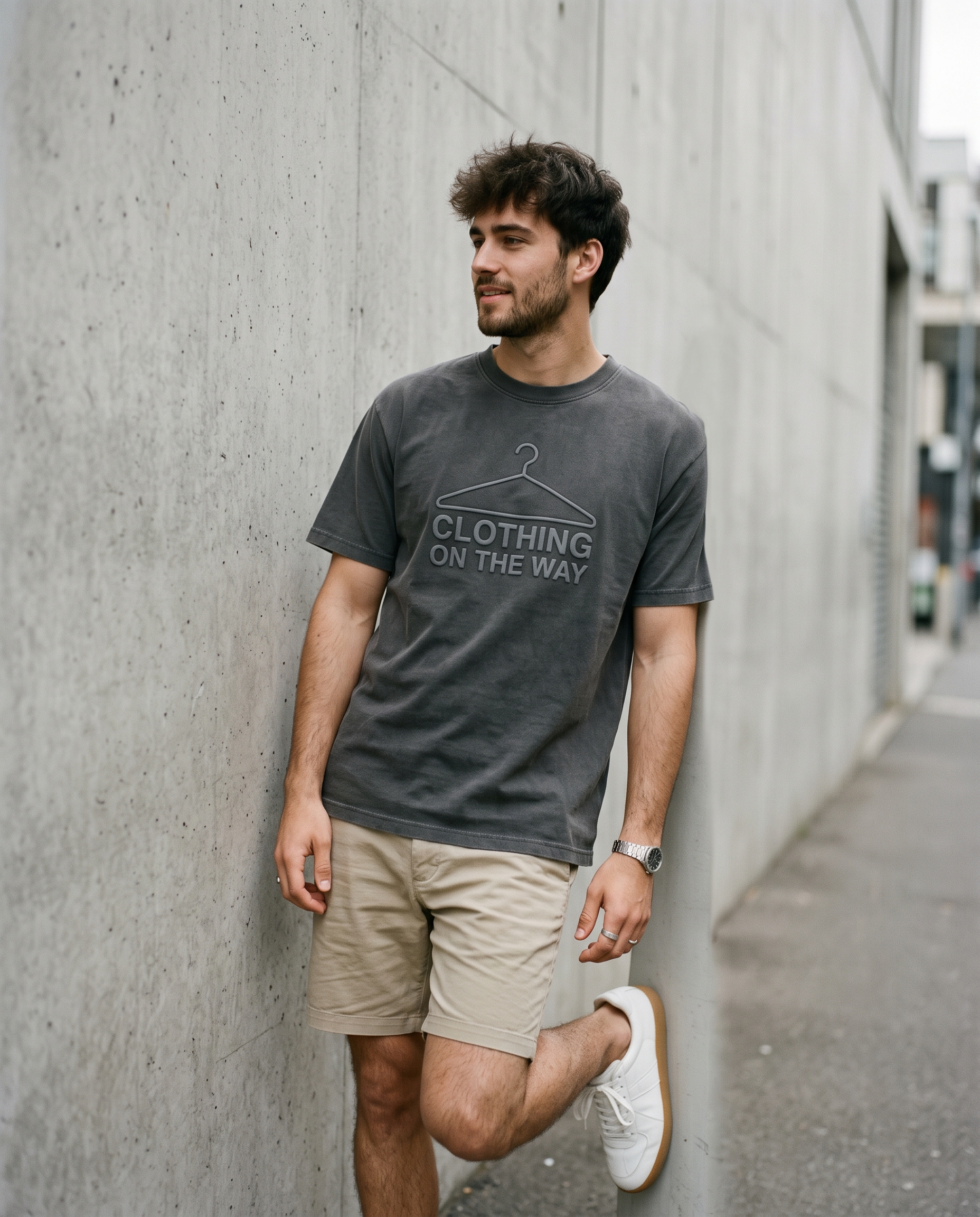 Model seen from behind in the bone back-print tee at golden hour